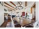 Elegant dining room with a large wooden table, chandelier, and scenic views at 6469 S Alameda Rd, Gold Canyon, AZ 85118