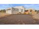 Front view of a stucco home with a large garage and desert landscaping at 6469 S Alameda Rd, Gold Canyon, AZ 85118