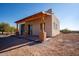 Charming stucco home with wood-beamed porch at 6469 S Alameda Rd, Gold Canyon, AZ 85118