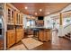 Rustic kitchen boasts custom wood cabinetry, a large island, and high-end appliances at 6469 S Alameda Rd, Gold Canyon, AZ 85118