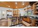 Kitchen with island, custom wood cabinetry, and a charming view from the window at 6469 S Alameda Rd, Gold Canyon, AZ 85118