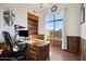 Home office with built-in shelves, large window, and wooden desk at 6469 S Alameda Rd, Gold Canyon, AZ 85118