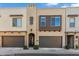 Tan two-story townhome with brown garage doors and landscaping at 7363 E Casitas Del Rio Dr, Scottsdale, AZ 85255