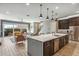 Open concept kitchen with island and living room view at 7363 E Casitas Del Rio Dr, Scottsdale, AZ 85255