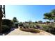 Stone patio overlooks a golf course with lush landscaping and mature trees at 7740 E Gainey Ranch Rd # 13, Scottsdale, AZ 85258