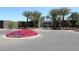 Attractive community entrance with lush landscaping and palm trees at 7740 E Gainey Ranch Rd # 13, Scottsdale, AZ 85258