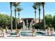 Resort-style community entrance with water fountain and palm trees at 7740 E Gainey Ranch Rd # 13, Scottsdale, AZ 85258