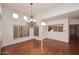 Dining room with hardwood floors and an elegant chandelier at 7740 E Gainey Ranch Rd # 13, Scottsdale, AZ 85258