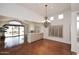 Bright dining room with hardwood floors, chandelier, and view to backyard at 7740 E Gainey Ranch Rd # 13, Scottsdale, AZ 85258