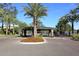 Gated entrance to the community with stonework and landscaping at 7740 E Gainey Ranch Rd # 13, Scottsdale, AZ 85258