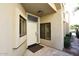 Front door entry with stone flooring and side windows at 7740 E Gainey Ranch Rd # 13, Scottsdale, AZ 85258