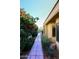 Stone pathway lined with vibrant bougainvillea at 7740 E Gainey Ranch Rd # 13, Scottsdale, AZ 85258