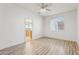 Simple bedroom with wood-look floors and a view into the kitchen at 8527 W Aster Dr, Peoria, AZ 85381