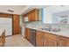 Kitchen with wood cabinets, tile floor, and stainless steel appliances at 8527 W Aster Dr, Peoria, AZ 85381