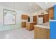 Kitchen features light wood cabinets, an island, and tile flooring at 8527 W Aster Dr, Peoria, AZ 85381