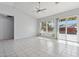 Bright living room with tile floors, sliding glass doors, and a ceiling fan at 8527 W Aster Dr, Peoria, AZ 85381