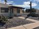 Desert landscape surrounds this single-story home with a covered patio at 867 E Lancaster Cir, Florence, AZ 85132