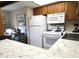 Bright kitchen features white appliances and wood cabinets at 867 E Lancaster Cir, Florence, AZ 85132