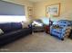 Living room features grey sofa and two patterned armchairs at 867 E Lancaster Cir, Florence, AZ 85132