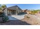 Landscaped backyard with a concrete patio and desert plants at 88 E Macaw Ct, San Tan Valley, AZ 85143