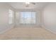 Well-lit bedroom with neutral walls and carpet at 88 E Macaw Ct, San Tan Valley, AZ 85143