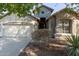 One-story house with neutral color exterior, two-car garage, and landscaping at 88 E Macaw Ct, San Tan Valley, AZ 85143