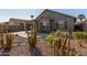 House exterior with desert landscaping and a covered patio at 88 E Macaw Ct, San Tan Valley, AZ 85143