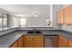 Kitchen with double sink and wood cabinets at 88 E Macaw Ct, San Tan Valley, AZ 85143