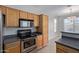 Kitchen with stainless steel appliances and wood cabinets at 88 E Macaw Ct, San Tan Valley, AZ 85143