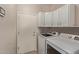 Bright laundry room with white cabinets and washer/dryer at 88 E Macaw Ct, San Tan Valley, AZ 85143