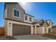 Beautiful two-story home featuring gray accents, a spacious two-car garage, and a well-maintained concrete driveway at 9227 E Sector Dr, Mesa, AZ 85212