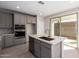 Well-appointed kitchen featuring gray cabinetry, a quartz countertop island with a sink, and stainless steel built-in appliances at 9227 E Sector Dr, Mesa, AZ 85212