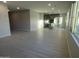 Open living room with light wood-look tile floors and views into the kitchen at 9227 E Sector Dr, Mesa, AZ 85212