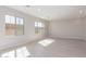 Light-filled living room with modern recessed lighting, wood-look flooring, and large windows offering bright, natural light at 9227 E Sector Dr, Mesa, AZ 85212