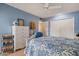 Light and airy bedroom with white furniture and wood floors at 9502 W Shasta Dr, Sun City, AZ 85351