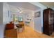 Bright dining area with wood flooring and view into kitchen at 9502 W Shasta Dr, Sun City, AZ 85351