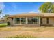 Rear view of the home showcasing a large sunroom at 9502 W Shasta Dr, Sun City, AZ 85351