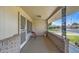 Covered porch with brick wall and small metal table at 9502 W Shasta Dr, Sun City, AZ 85351