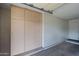 Garage with built-in storage cabinets and ample space at 9502 W Shasta Dr, Sun City, AZ 85351