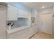 Bright kitchen with white cabinets and electric cooktop at 9502 W Shasta Dr, Sun City, AZ 85351