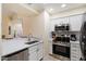 Modern kitchen with stainless steel appliances and white cabinetry at 9708 E Via Linda -- # 2313, Scottsdale, AZ 85258