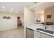 Kitchen with granite countertop and view into bedroom with a bed at 9708 E Via Linda -- # 2313, Scottsdale, AZ 85258