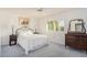 Bedroom with vintage dresser and window shutters at 9920 W Shasta Dr, Sun City, AZ 85351