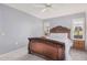 Spacious bedroom with ornate wooden bed frame and ensuite access at 9920 W Shasta Dr, Sun City, AZ 85351