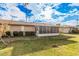 Rear view of the house showcasing the screened patio and landscaping at 9920 W Shasta Dr, Sun City, AZ 85351