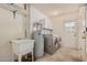 Laundry room with utility sink, water heater and cabinets at 9920 W Shasta Dr, Sun City, AZ 85351