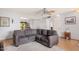 Bright living room with sectional sofa and wood flooring at 9920 W Shasta Dr, Sun City, AZ 85351