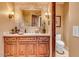 Elegant bathroom with wood vanity and tile accents at 10473 E Greythorn Dr, Scottsdale, AZ 85262