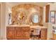 Elegant bathroom with double sinks and wood cabinets at 10473 E Greythorn Dr, Scottsdale, AZ 85262