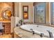 Relaxing bathroom with a large soaking tub and window at 10473 E Greythorn Dr, Scottsdale, AZ 85262